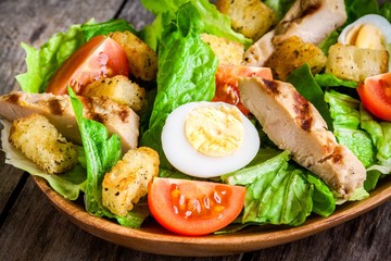 Caesar salad with croutons, cherry tomatoes and grilled chicken