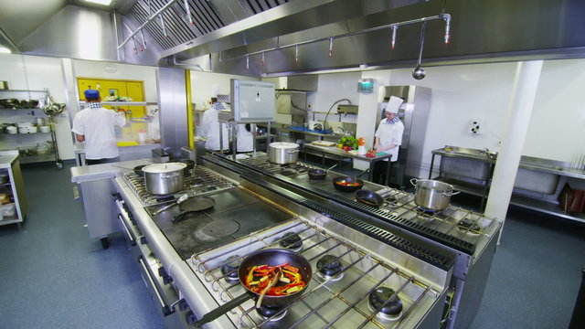 Time lapse of a busy team of chefs preparing food in a commercial kitchen