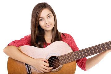 Pretty teenage girl playing an acoustic guitar