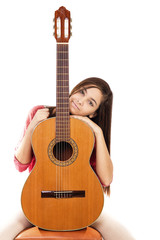 Portrait of pretty teenage girl and her guitar