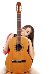Portrait of pretty teenage girl and her guitar