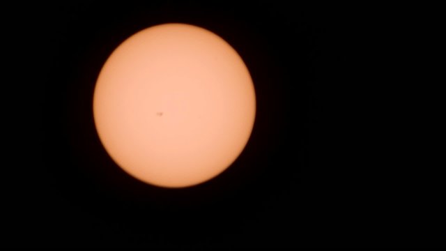 Sun through telescope. With sunspots and atmosphere distortion.