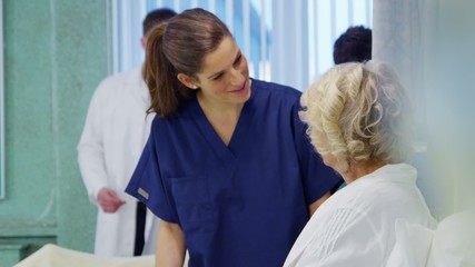 Medical staff working together and taking care of patients on a hospital ward - Powered by Adobe