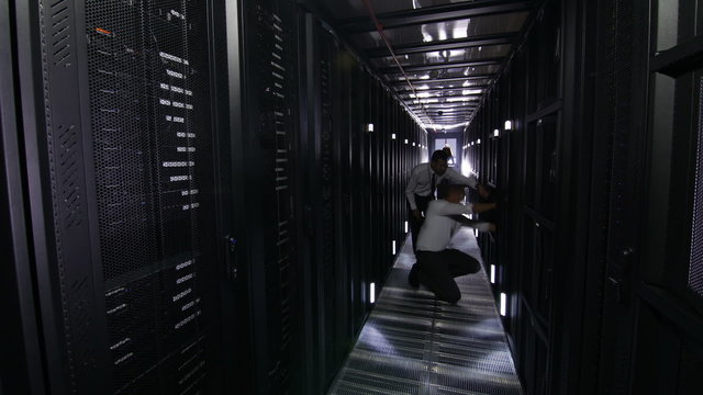 Time lapse of IT engineers working in a data centre