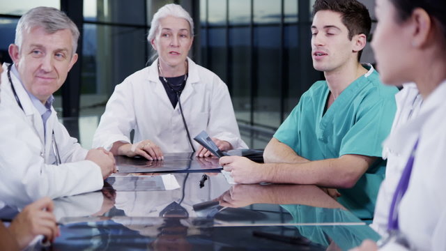 Multi ethnic medical team in a meeting discuss a patient's x-ray results