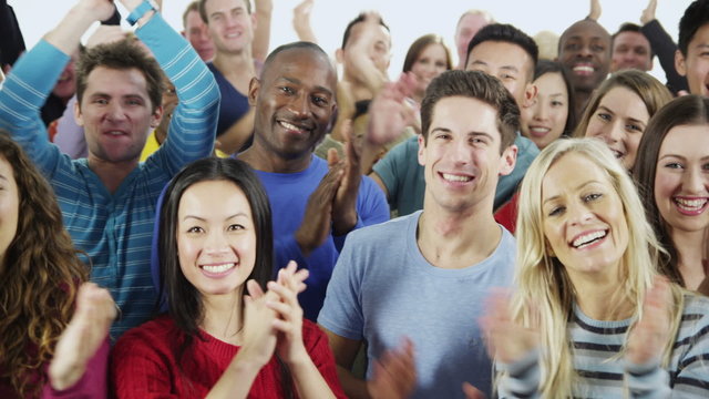 Happy, diverse group in casual clothing smiling and clapping