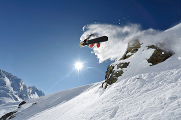 Naklejka na ściany i meble Snowboarder pulls off a “Method Air” in the backcountry