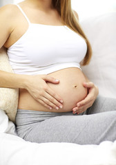 close up of happy pregnant woman at home