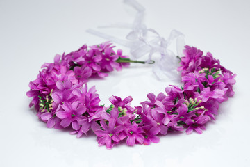 tiara of artificial  roses on a light background