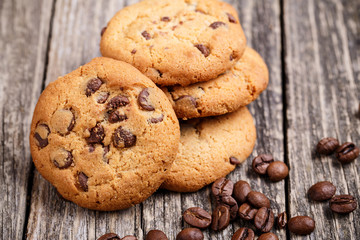 Cookies and coffee beans on a wooden table.