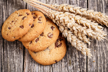 Cookies with wheat on a wooden table.