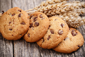 Cookies with wheat on a wooden table.