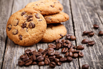 Cookies and coffee beans on a wooden table.