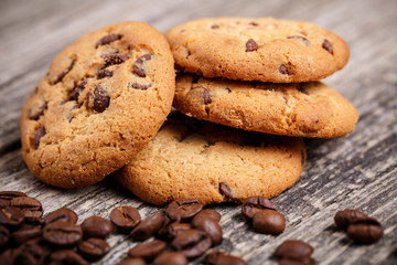 Cookies and coffee beans on a wooden table.