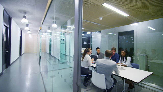 Attractive young business team in a meeting in modern city office. 