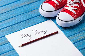 Obraz premium pencil and paper with My Story words near gumshoes