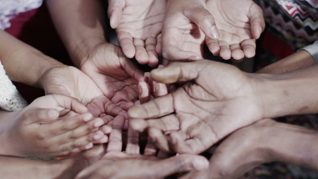 Many hands reaching out, begging for food or money