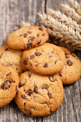 Cookies with wheat on a wooden table.
