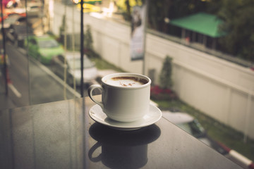 Coffee cup in coffee shop - vintage style effect picture