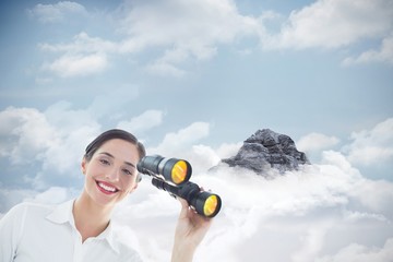 Composite image of smiling business woman with binoculars