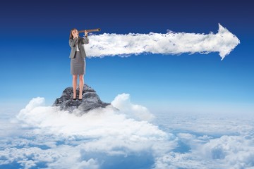 Composite image of businesswoman looking through a telescope