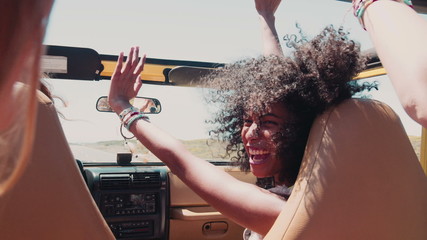 Afro girl laughing with friends on a road trip vacation - Powered by Adobe