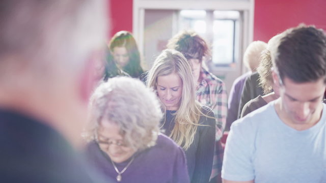 Church group bow their heads to pray