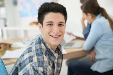 Portrait of college boy attending class