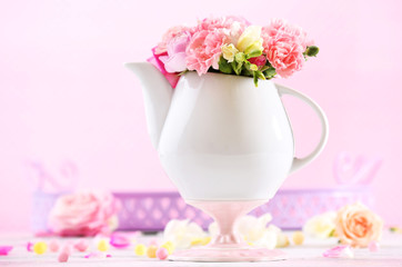 Composition with beautiful spring flowers in teapot
