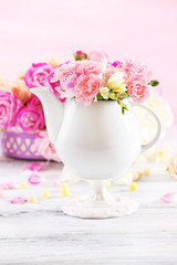 Composition with beautiful spring flowers in teapot