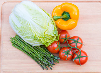 Fresh vegetables on wooden cutting board
