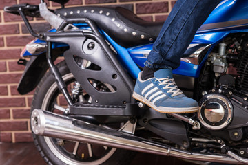 Fototapeta na wymiar Person Standing on Foot Pegs of Cruiser Motorcycle