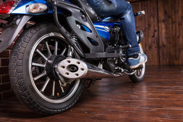 Man sitting on a motorbike indoors