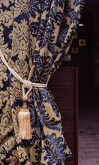Beautiful curtain with a tassel in a fashionable apartment