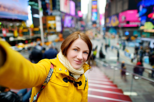Beautiful woman taking a selfie on Times Square