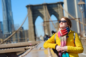 Young woman sightseeing on Brooklyn Bridge