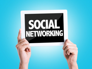 Tablet pc with text Social Networking with blue background