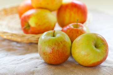 Fresh red and green apples on a vintage quilt