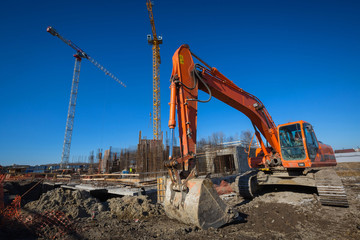 Fototapeta premium Yellow excavator on a construction site