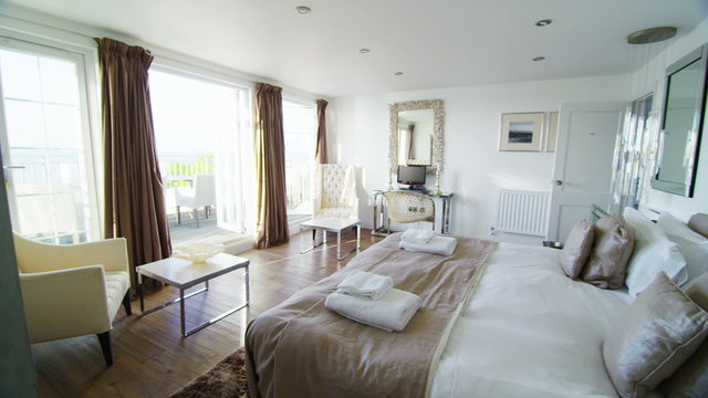 Interior view of bedroom in a stylish beachside home. No people.