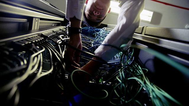 IT engineer working on server wiring in a data centre