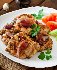Sliced pork grilled with vegetables on white plate