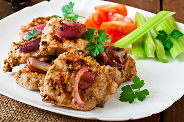 Sliced pork grilled with vegetables on white plate