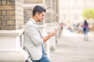 Attractive young man using mobile phone