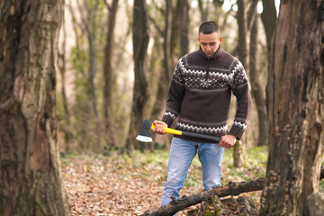 Portrait of young lumberman holding an axe