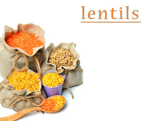 green, red and yellow lentils in the sacks and spoon wooden isol