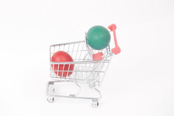 Easter colorful painted eggs in the shopping cart and near the t