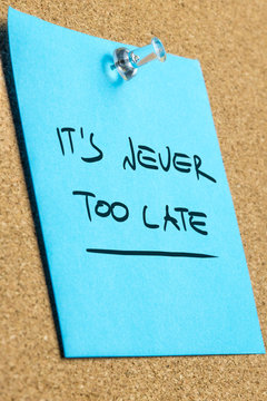 Its Never Too Late Phrase on Pinned Sticky Note