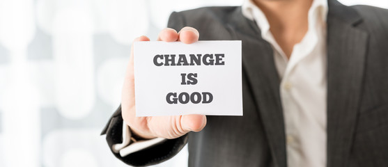 Businessman Showing Card with Change is Good Texts