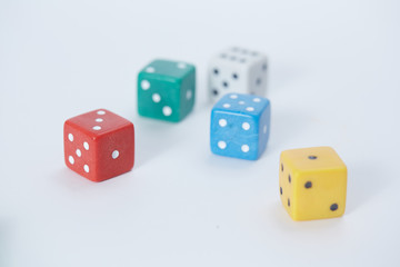 colored playing dice in a chaotic manner on a white background